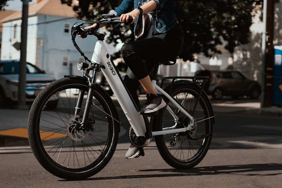 A person riding an electric bike on a scenic path, showcasing the ease and enjoyment of cycling with an e-bike.