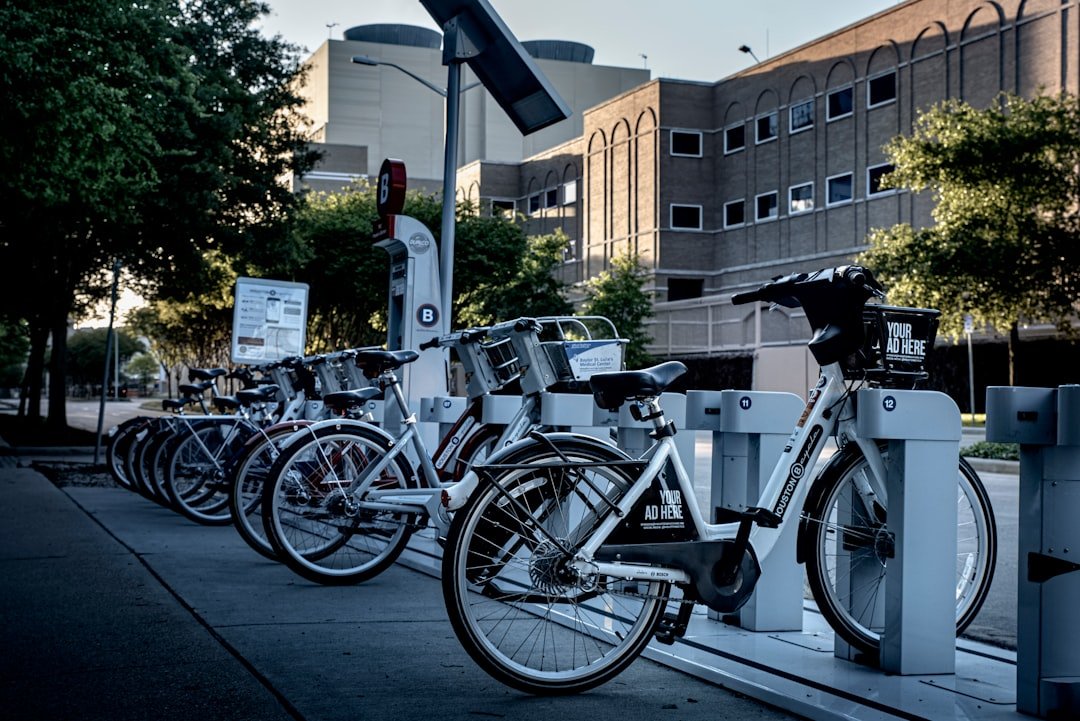 A close-up of an electric bike being charged, showcasing the charging port and cable.