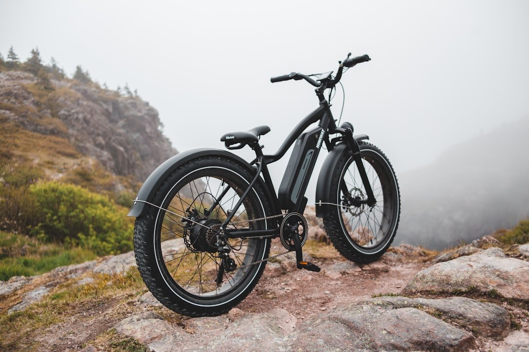 A close-up of an electric bike showcasing its frame and components, emphasizing its weight and design.