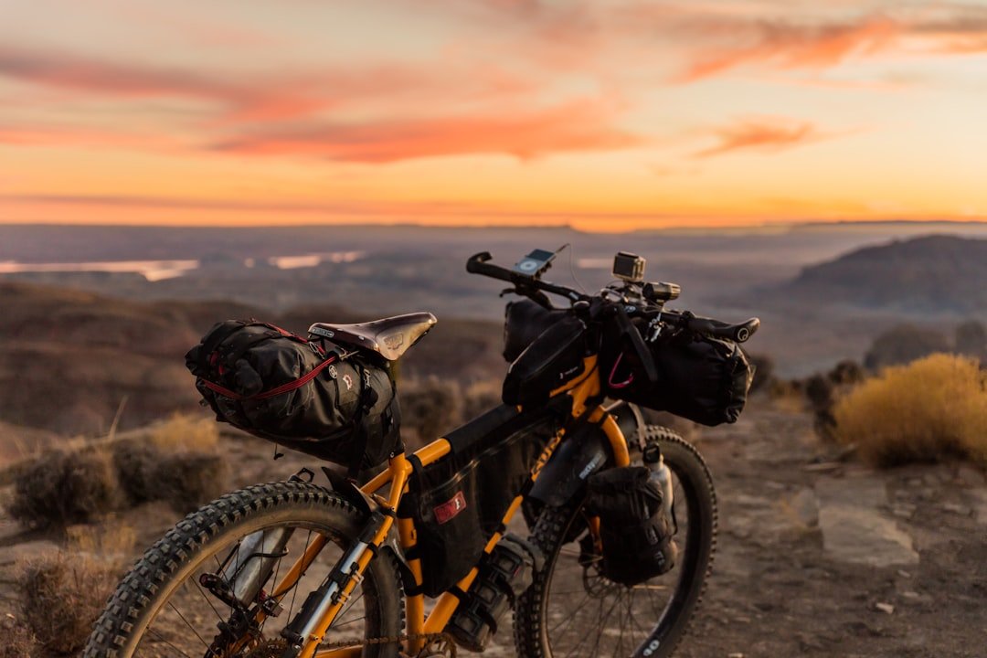A scenic view of an electric bike parked on a trail with mountains in the background, symbolizing adventure and exploration.